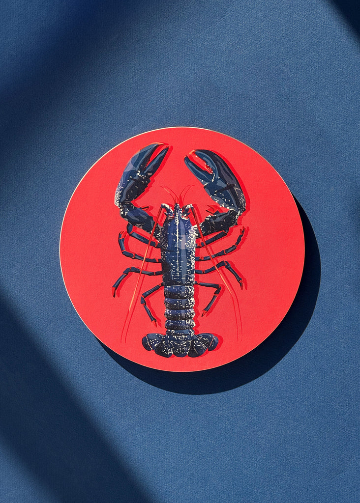 Dessous de plat avec l'illustration d'un homard bleu sur fond rose