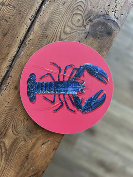 Dessous de plat avec l'illustration d'un homard bleu sur fond rose